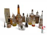 many bottles of different sizes and shapes on a white surface