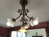 un lustre au milieu d'une pièce où se trouvent une table et des chaises