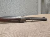 an old gun laying on top of a table next to a wall