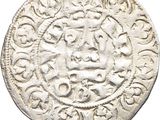 an old silver coin with a design on it