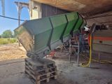 un bateau vert posé sur une palette dans un garage