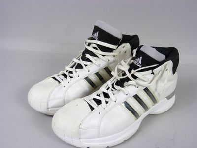 adidas shoes with black and white stripes are on a white surface