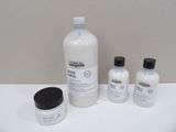 a bottle of lotion and two bottles of lotion sitting on a table