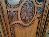 a wooden cabinet with a mirror on top of it