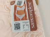 pink lace panties with a tag on top of them