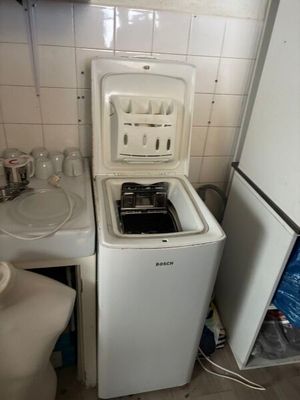 a small kitchen with a washing machine and a sink