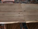 a wooden table with four chairs around it on a tiled floor
