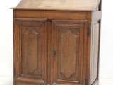 a wooden cabinet with a door and a drawer on it