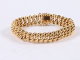 a gold bracelet with a braid design