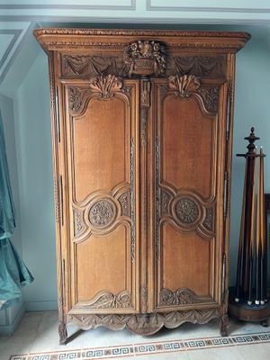 a large wooden cabinet in the corner of a room
