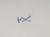 a white plate with a blue and white design on it
