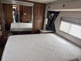 a bedroom with a bed and a mirror in it