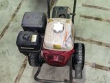 an image of a small gas powered lawn mower in a garage