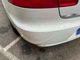 a white car that is parked in a parking lot