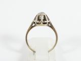 an antique silver ring with a diamond set in the center