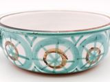 a bowl with a handle that has a design on it