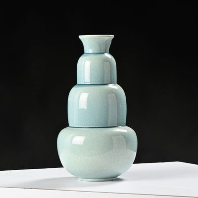 a blue vase sitting on top of a white table
