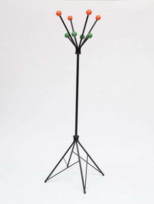 a black metal coat stand with orange and green balls on it