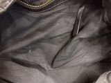 the inside of a black purse with a zipper on it