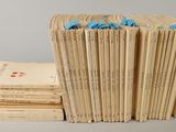 several books stacked on top of each other on a table