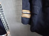 a picture of a uniform and a tie hanging on a rack