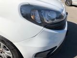 a white car parked in a parking lot with other cars in the background