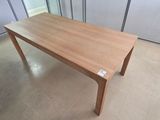 a wooden table in the middle of a room