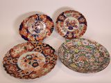 three plates with different designs on them sitting on a white surface