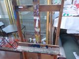 a picture of a painting easel with a lot of paint on it