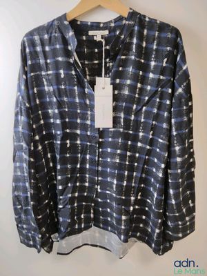 a close up of a shirt on a hanger on a wall