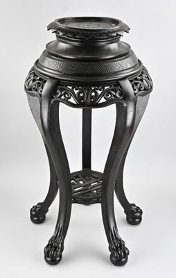 an image of a black vase on a stand on a white background