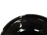 a black bowl sitting on a table with a white background