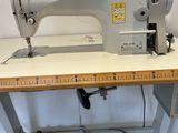 a sewing machine sitting on top of a wooden table