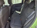 a green car with black seats in the back of it