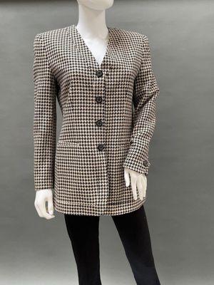 a mannequin wearing a black and white checkered jacket and leggings