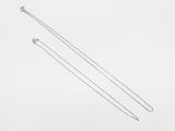 a pair of silver necklaces on a white background