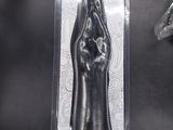 an image of a black hand shaped object in a plastic package