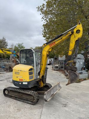 a yellow and black excavator that is parked in a lot