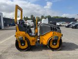 a picture of a yellow roller is parked in a parking lot