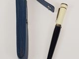 an image of a pen and a pen holder on a white surface