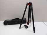 a close up of a tripod and a bag on a table