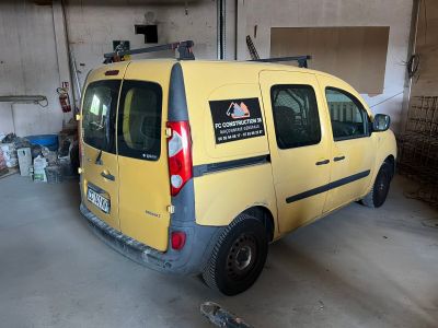a yellow van parked in a garage with a sign on the back of it