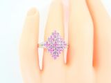 an image of a woman ' s hand with a pink ring on it