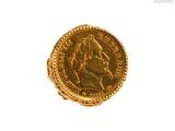 l'image d'une pièce d'or sur laquelle figure le visage d'un homme