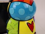 a colorful figurine that is next to a cell phone