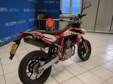 a red and black motorcycle parked in a showroom