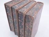five books stacked on top of each other on a white surface