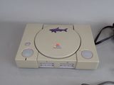 a video game console with a fish sticker on it