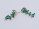 a pair of green glass earrings on a white background