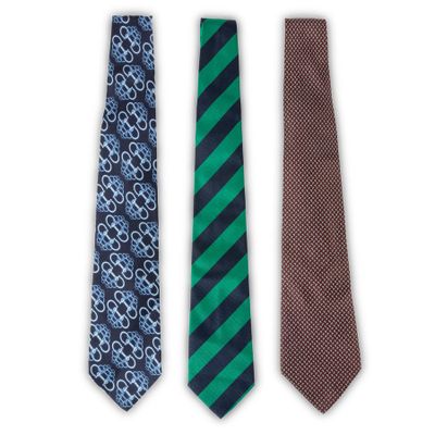 three ties are lined up in a row on a white background